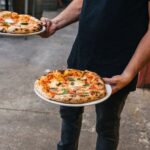 Man Holding Pizzas Cropped.jpg