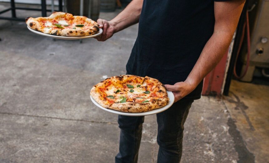 Man Holding Pizzas Cropped.jpg