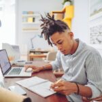 Young Man Looks Over His Investment Accounts Hs5myzt.jpg