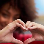 Woman Forming A Heart Shape With Her Fingers.jpg